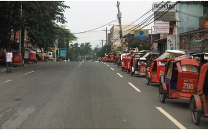 <p><strong>POSSIBLE EXEMPTION.</strong> Tricycles parked along the sides of a street. While all public transportation remains banned in areas under the modified enhanced community quarantine, an exception may be given to tricycle operations depending on the decision of local government units and the Department of the Interior and Local Government. <em>(File photo)</em></p>